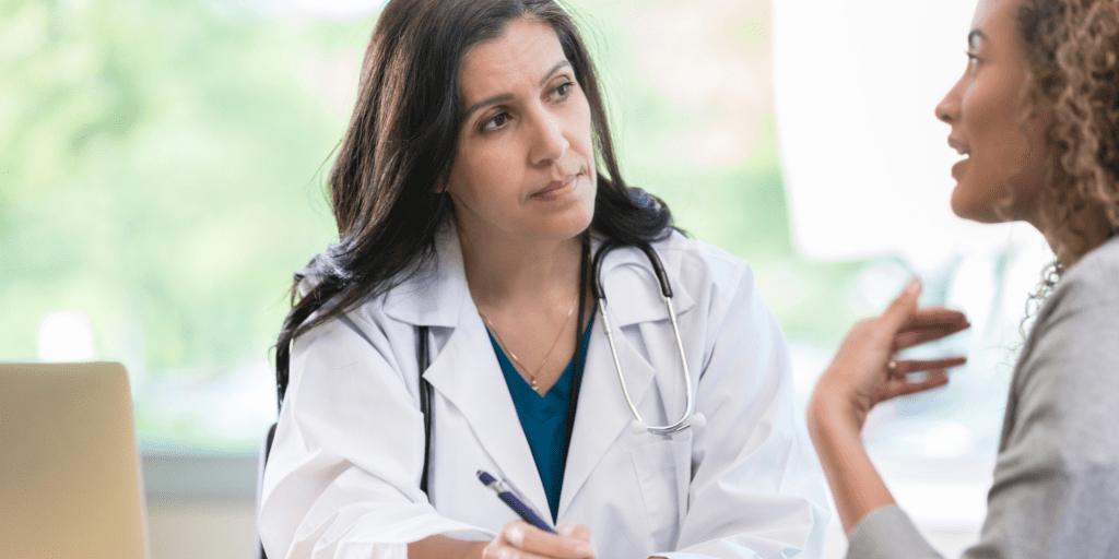 female doctor listening to patient